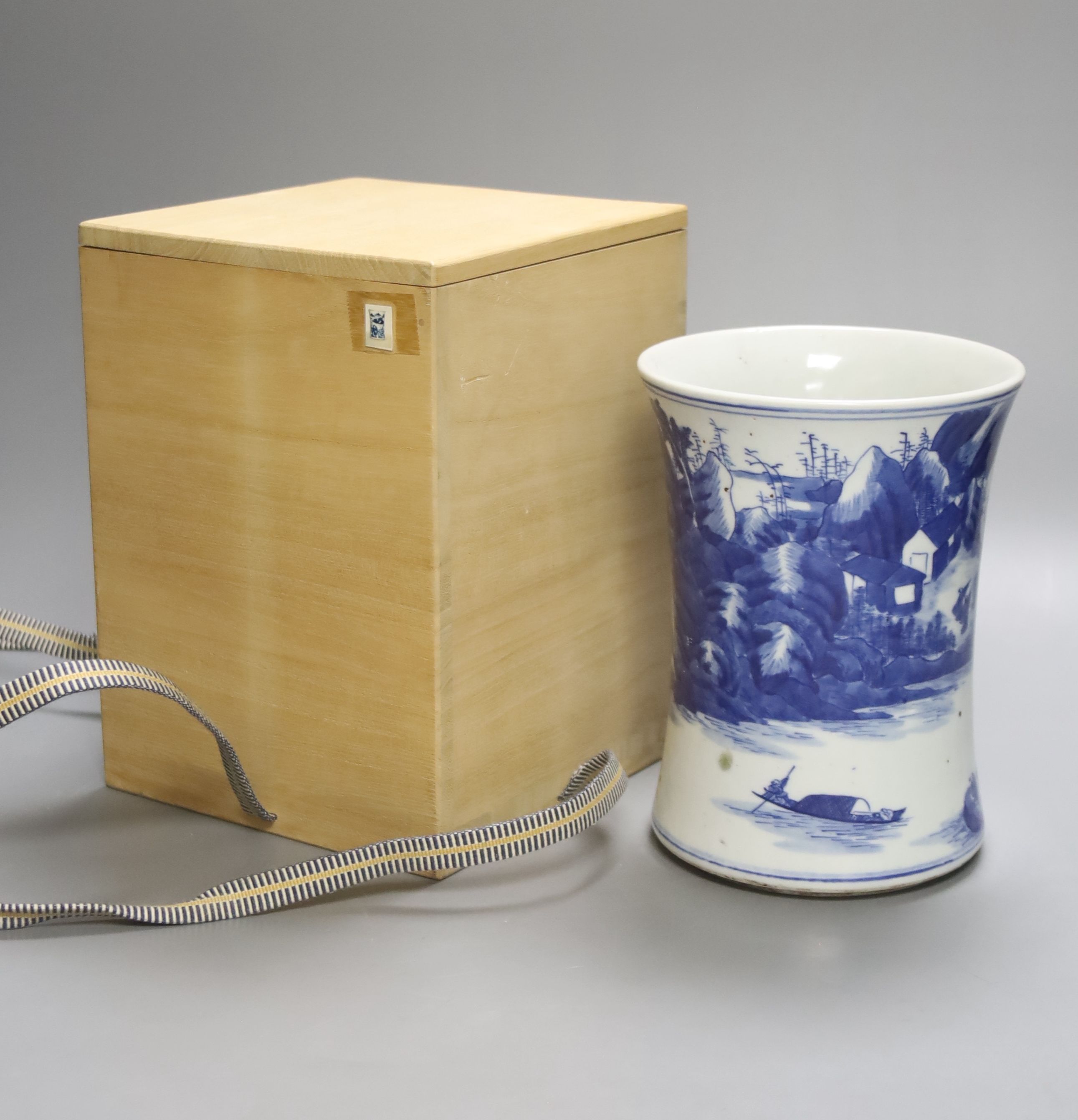 A Chinese blue and white porcelain brush pot, painted with a landscape, 17cm high, in later pine box